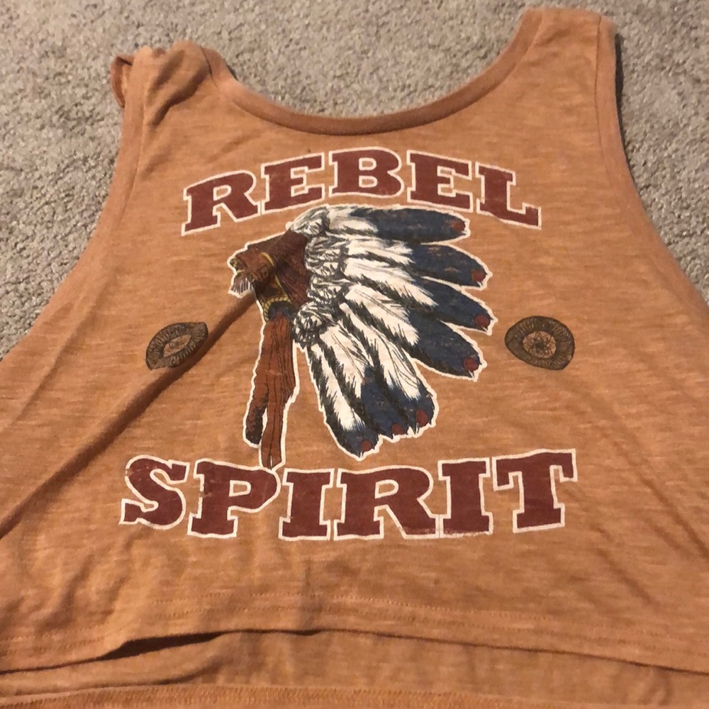 A orange crop top that says rebel spirit on it